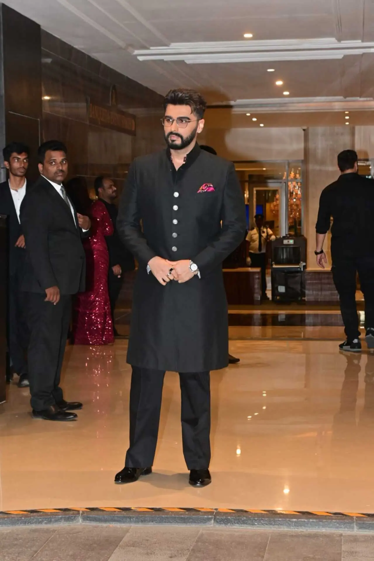 Arjun Kapoor was spotted attending a wedding celebration, looking dapper in a classic black traditional ensemble. The actor wore a sleek black bandhgala kurta paired with matching trousers.
